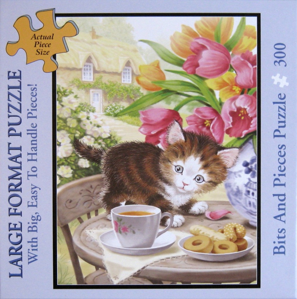A fluffy brown and white kitten exploring a table set for tea in a garden