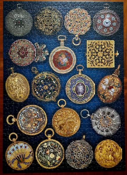 A collection of ornate, historical pocket watches arranged against a deep blue background.