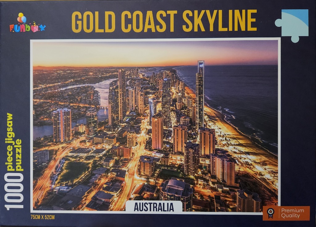 Aerial evening view of the Gold Coast skyline in Australia with glowing skyscrapers and city lights.