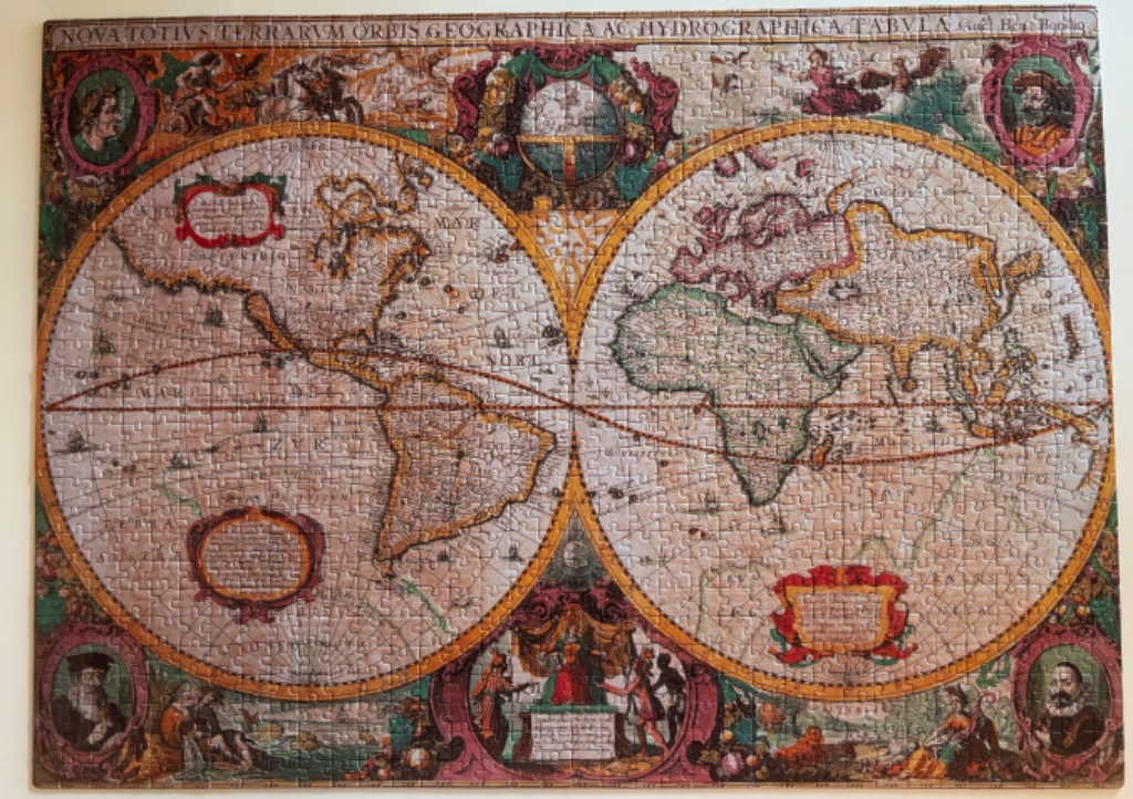 An antique-style double-hemisphere world map featuring ornate borders, vignettes, and historical cartography.