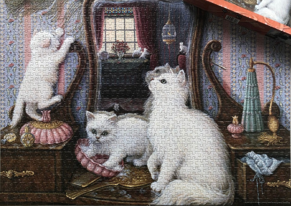Three fluffy white kittens playing on and around a vintage vanity table in a Victorian-style room.