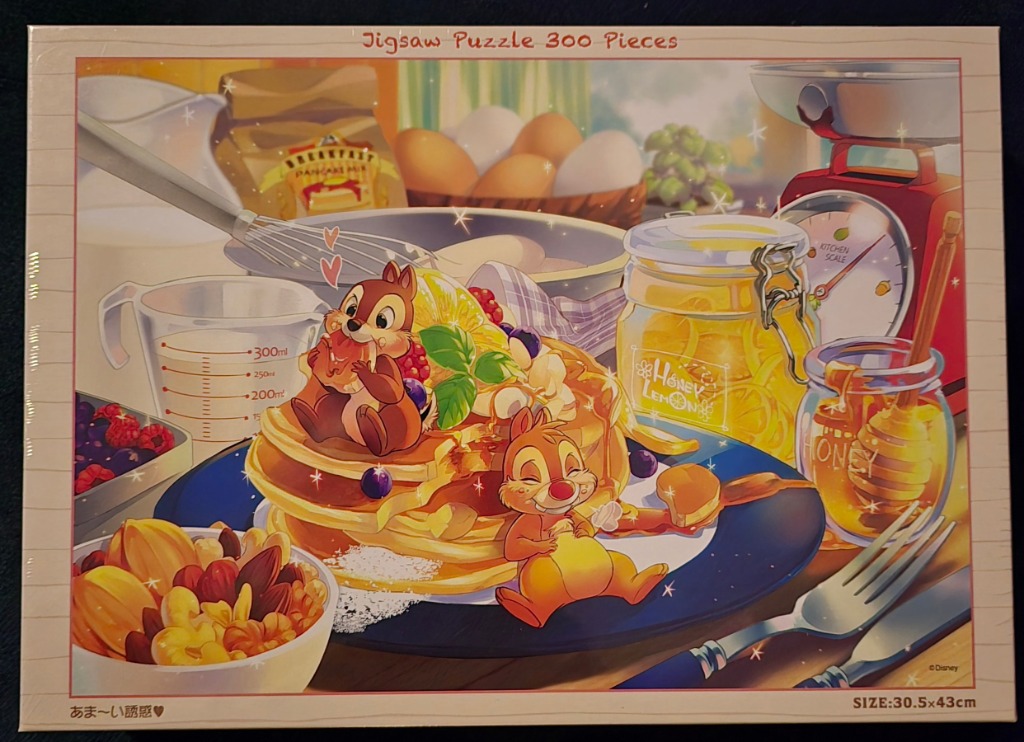Chip and Dale sitting on a stack of pancakes surrounded by breakfast ingredients in a vibrant, artistic illustration.