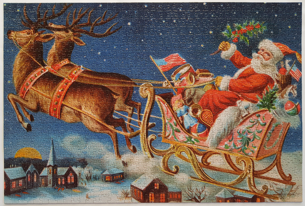 Santa Claus in his reindeer-drawn sleigh flying over a snowy village at night.
