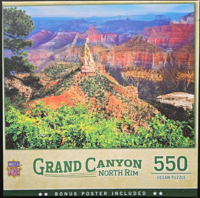 A panoramic landscape photograph looking over the Grand Canyon North Rim with a prominent rocky spire in the center.