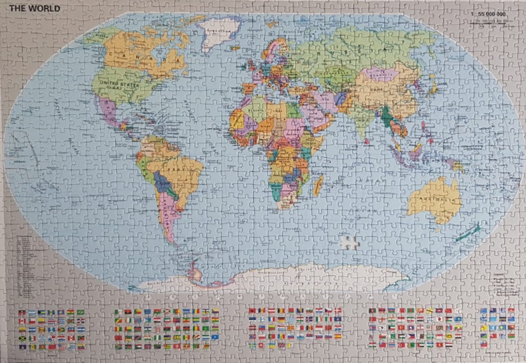 An oval-shaped political map of the world against a light grey background with a grid of national flags below.
