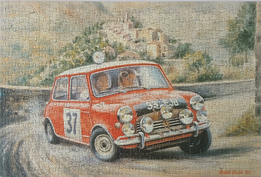 Watercolor painting of a red rally Mini Cooper navigating a mountainous road
