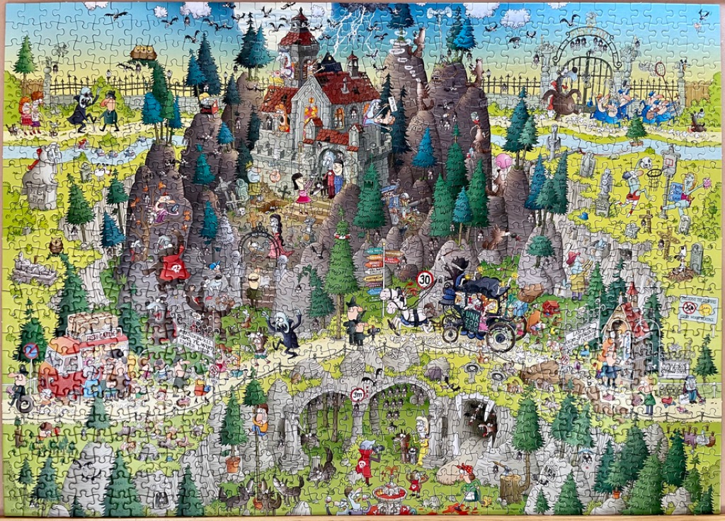 Cartoon illustration of a spooky, chaotic monster-filled castle on a rocky hill.