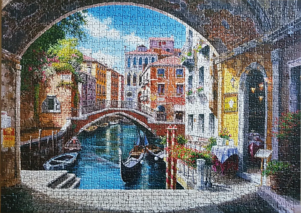 An oil painting style view of a Venetian canal scene framed by a stone archway.