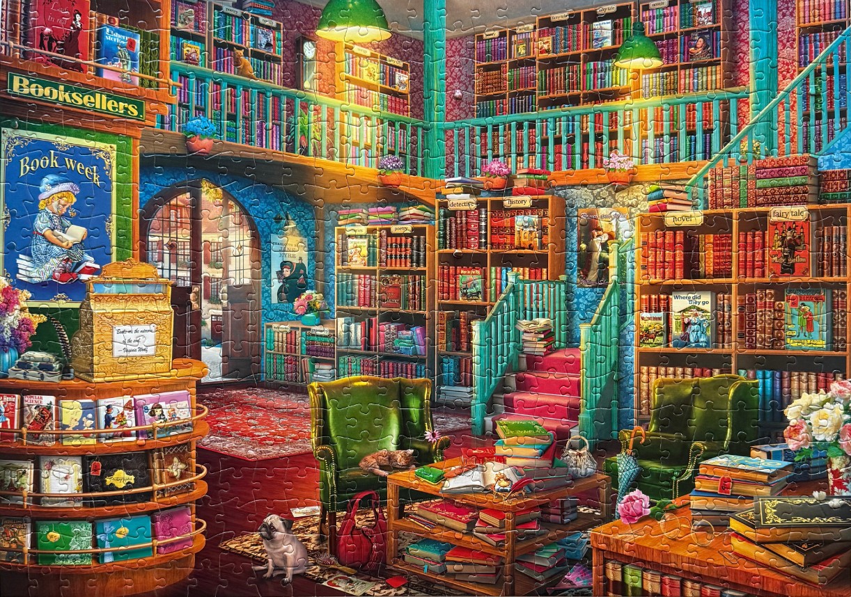 A cozy, multi-level bookshop filled with shelves, antique furniture, and pets.