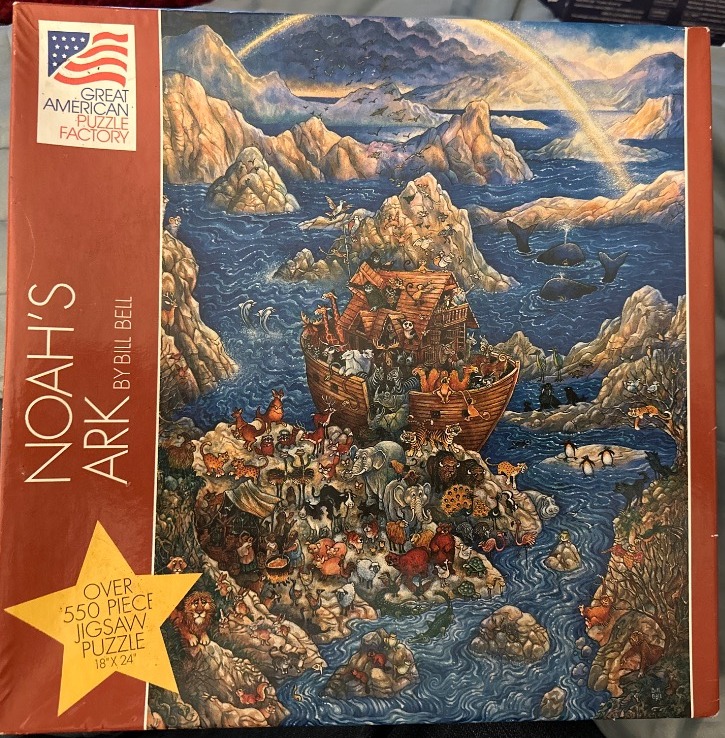 A vibrant painting of Noah's Ark crowded with animals on a rocky shoreline with a rainbow in the sky.