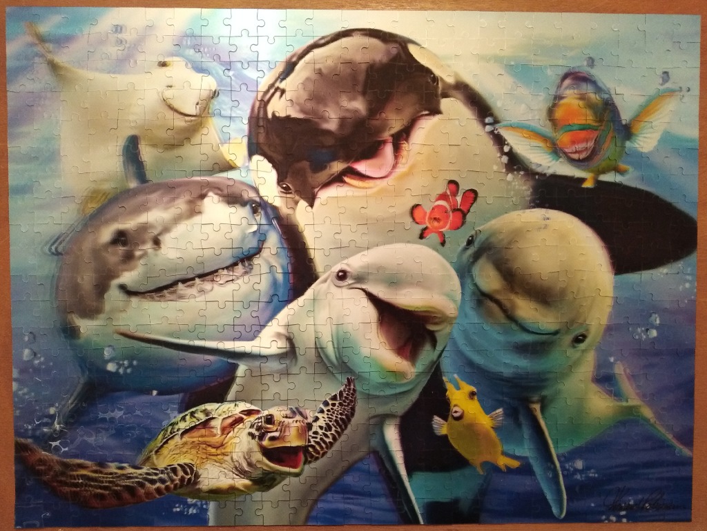 A collection of friendly, smiling sea creatures gathered together underwater.