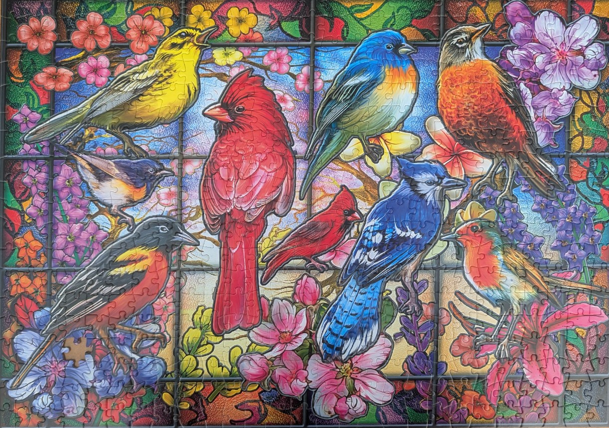 Stained glass style illustration of eight colorful songbirds perched among cherry blossoms.