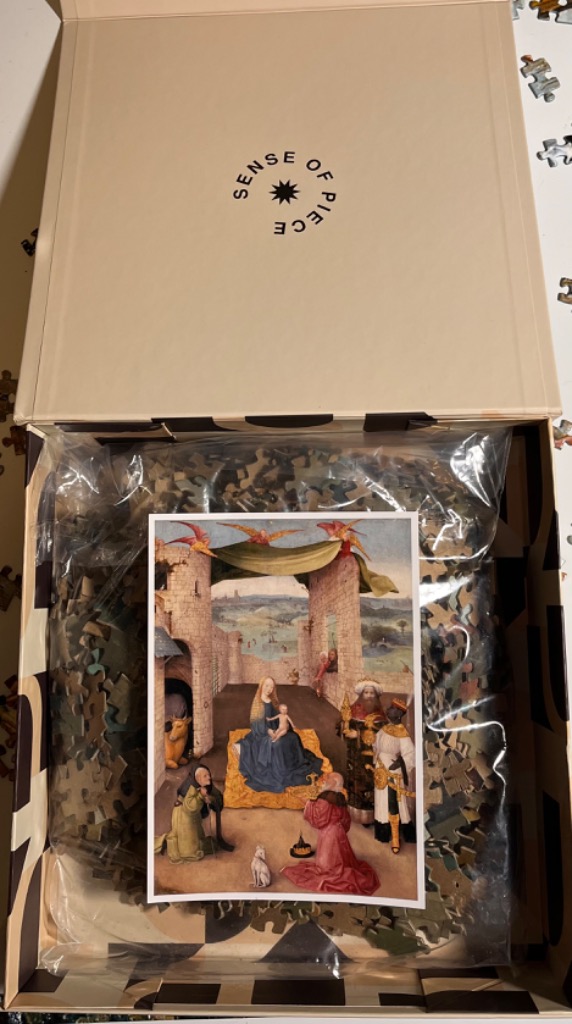 A Renaissance painting of the Adoration of the Magi inside a box.