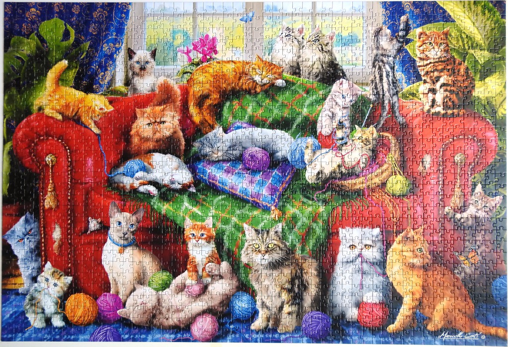A whimsical illustration of many cats playing on and around a large red sofa.