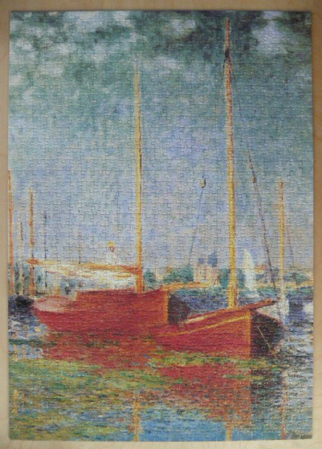 Impressionist painting of two red sailboats moored on a harbor under a stormy sky.