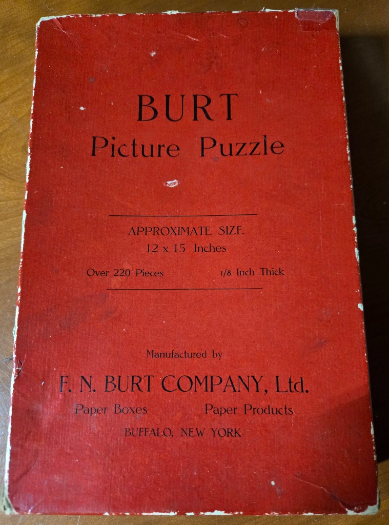 A rectangular red surface featuring black text details regarding dimensions and manufacturing information.