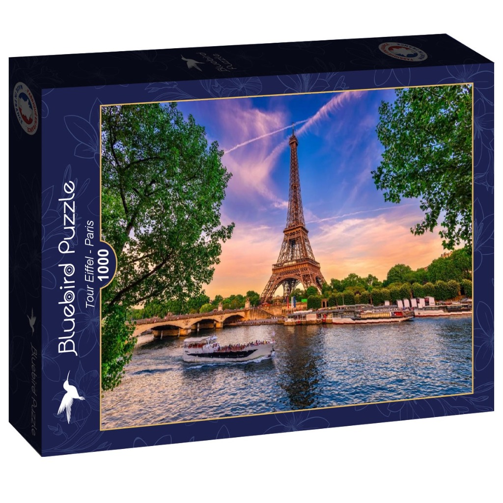 The Eiffel Tower viewed from the Seine River in Paris at sunset, with a tour boat in the foreground.