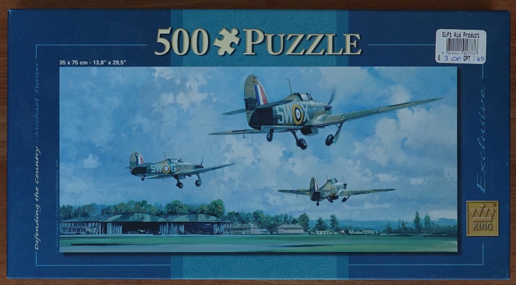 Painting of three vintage military aircraft taking off from an airfield in front of hangars.
