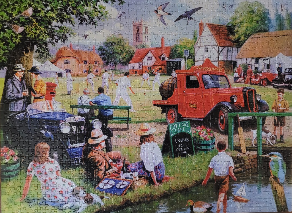 A detailed nostalgic scene of a village cricket match with spectators, a vintage red truck, and a stream in the foreground.
