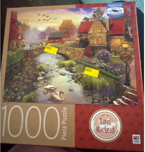 An idyllic countryside scene with a stone bridge, swans on a stream, a red barn, and a cottage at sunset.