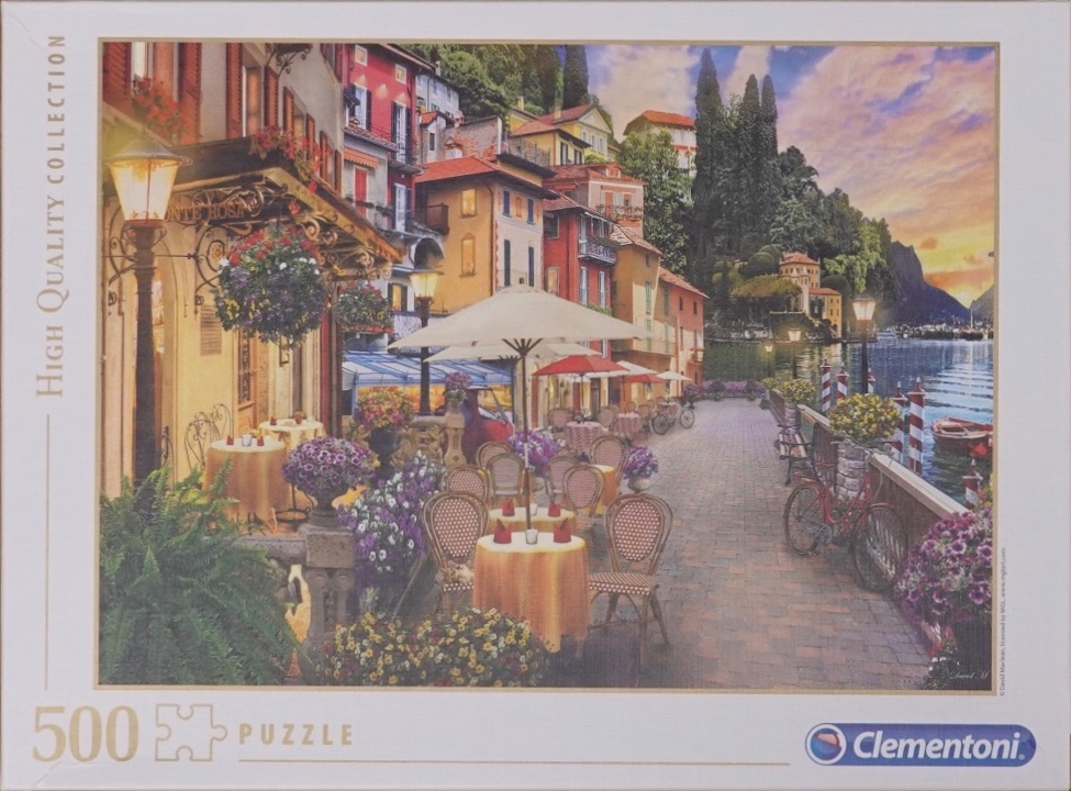 A charming lakeside restaurant terrace in an Italian village at sunset