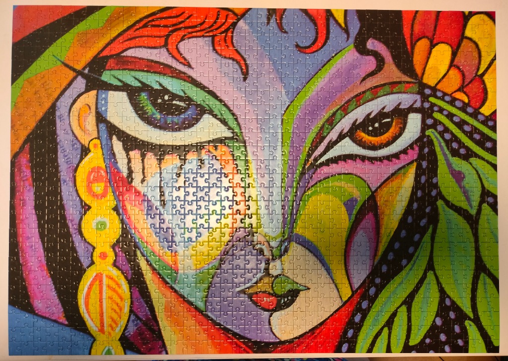 A vibrant cubist-style portrait featuring a stylized woman's face with bold colors and intricate patterns.