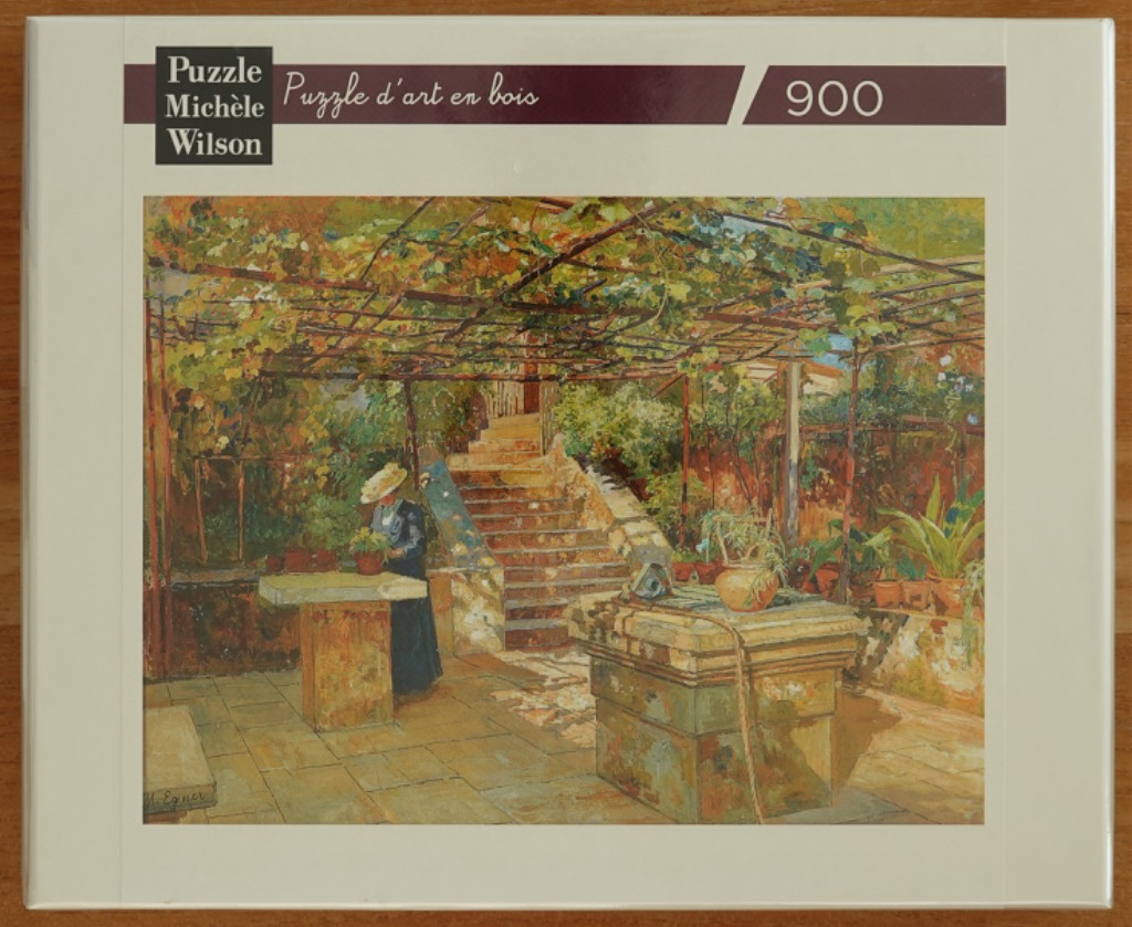 Impressionist painting of a woman in a hat standing in a sunny garden with a vine-covered trellis and stone stairs.