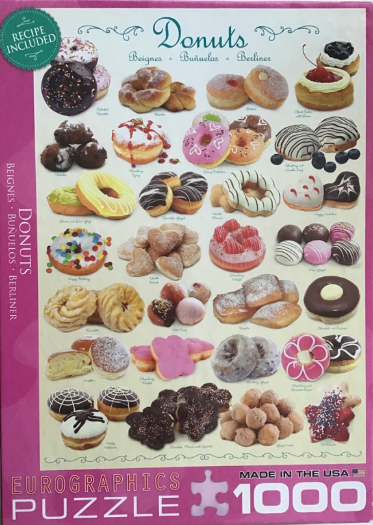 A collection of various donuts and fried pastries displayed on a white background.