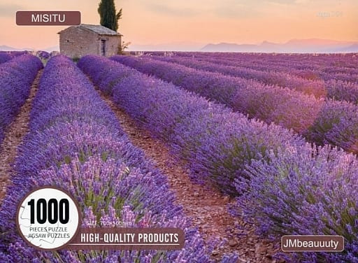 A scenic photograph of vibrant, purple lavender fields in Provence at sunrise with a small stone hut.