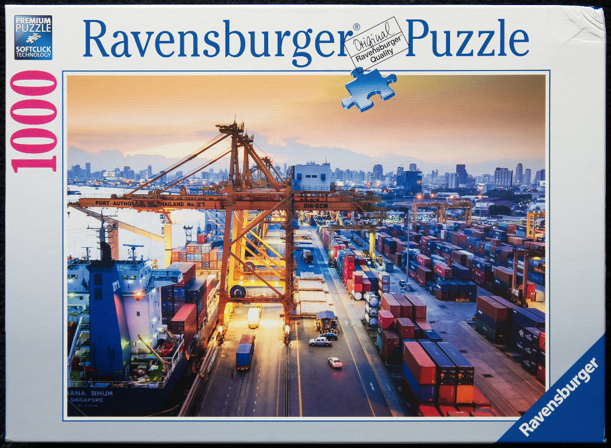 Industrial shipping port at sunset with large cranes and cargo containers