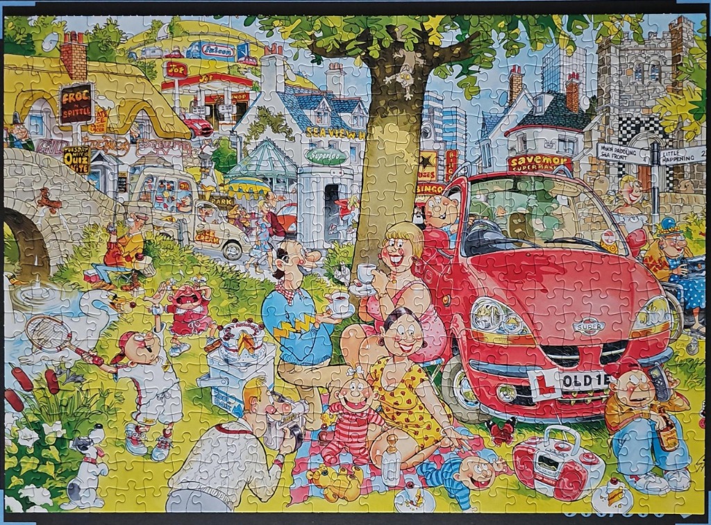 Humorous picnic scene with a red car, families, ice cream van, and village buildings.