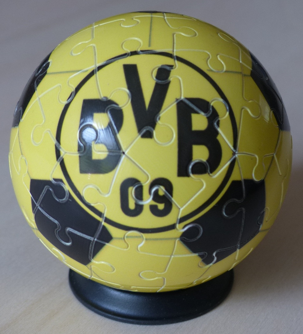 A spherical soccer ball styled object with a yellow and black BVB 09 logo on a stand.