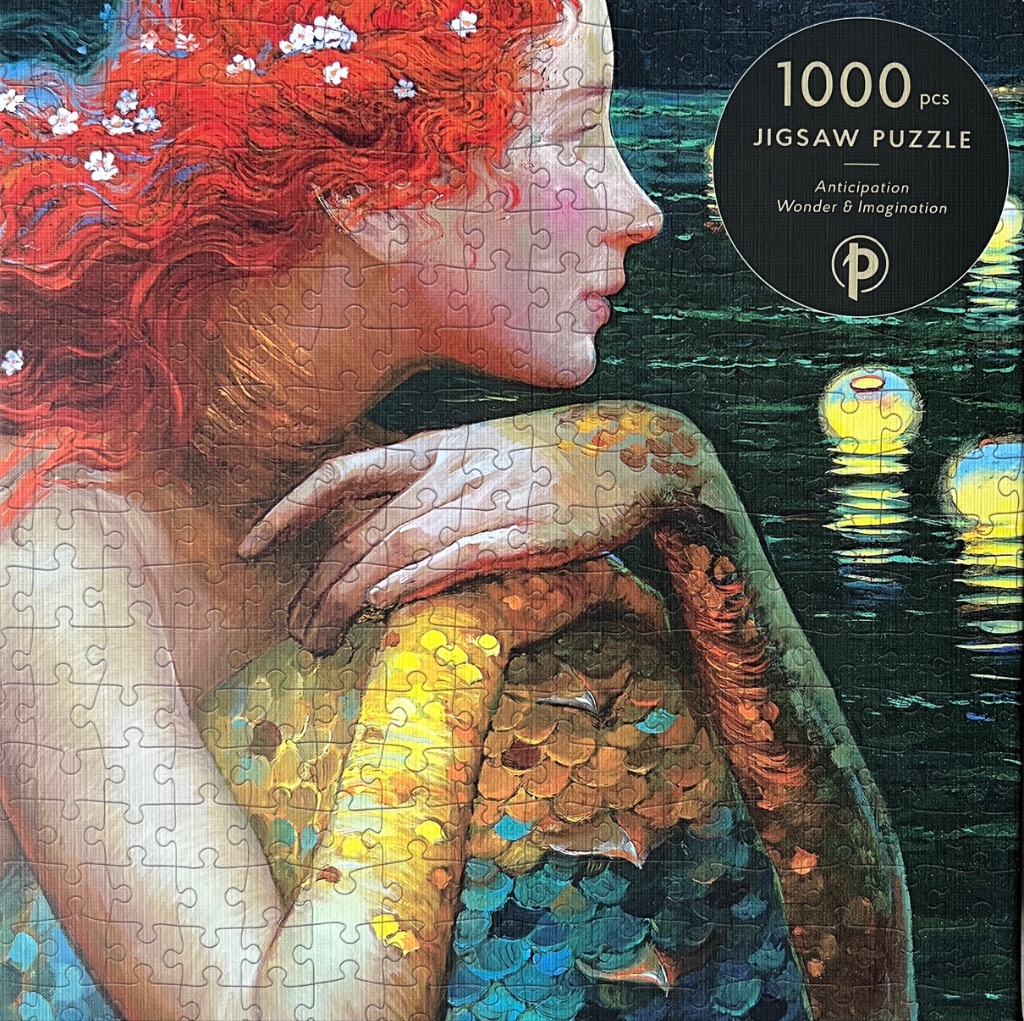 A side profile of a woman with long red hair and a shimmering, scale-covered torso overlooking dark moonlit water.