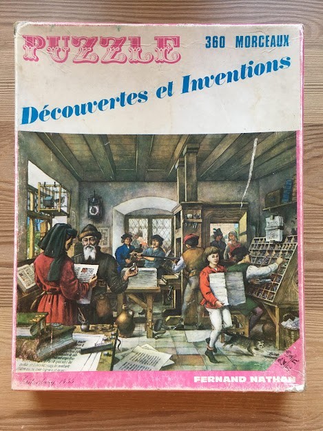An illustration of a 15th-century printing press workshop with multiple people working.