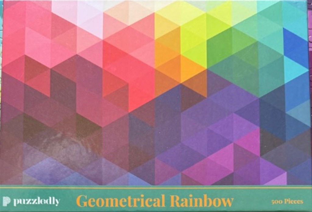 Abstract geometric pattern consisting of triangles of various rainbow colors that blend into one another.