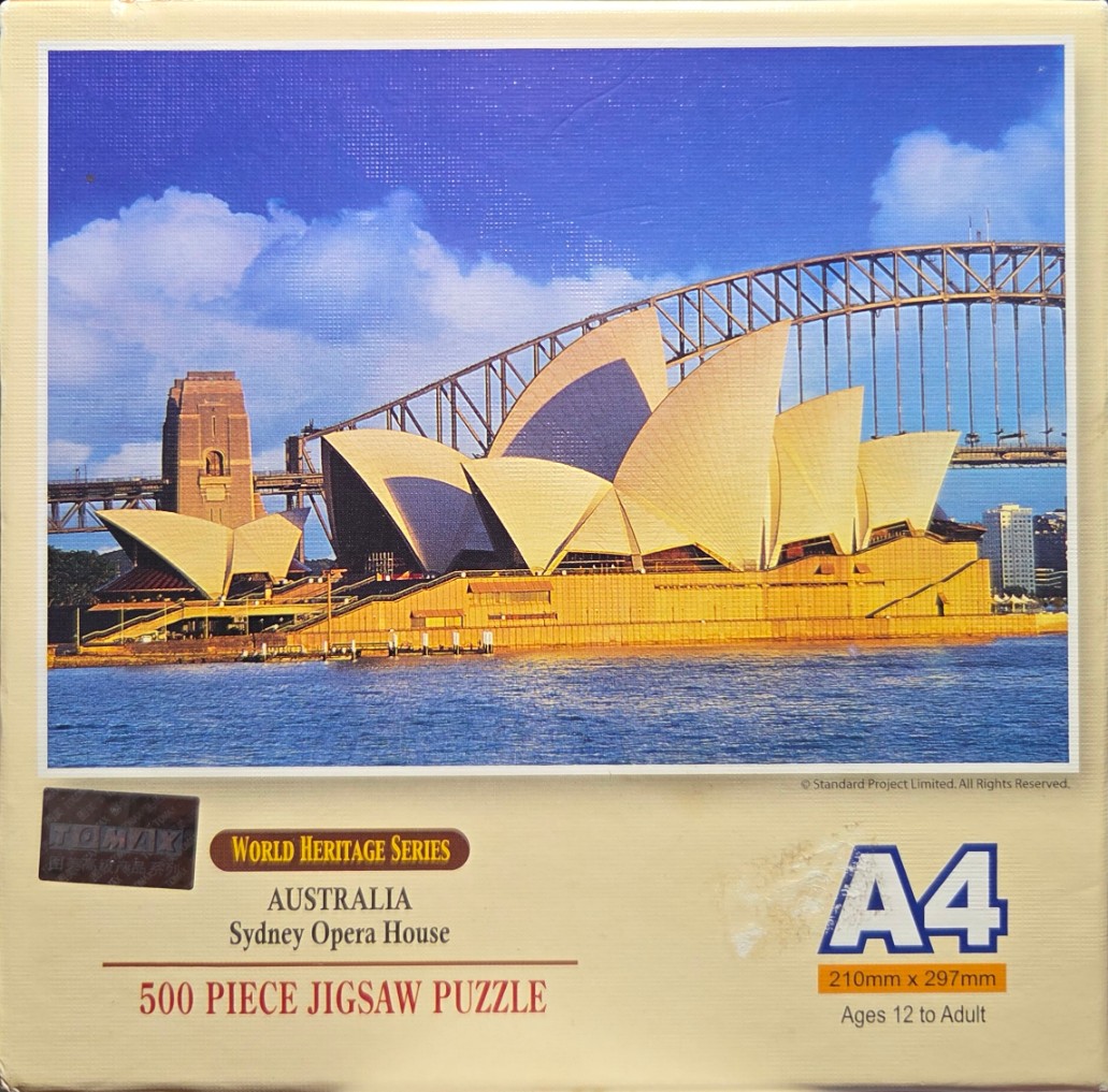 The Sydney Opera House and Sydney Harbour Bridge under a bright blue sky.