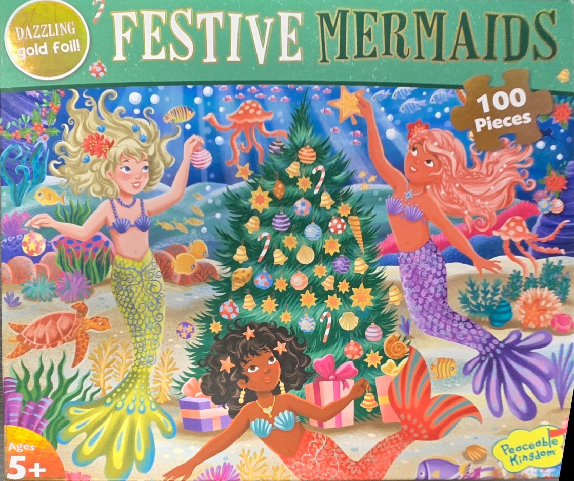 Three diverse mermaids decorating an underwater Christmas tree surrounded by coral and sea life.