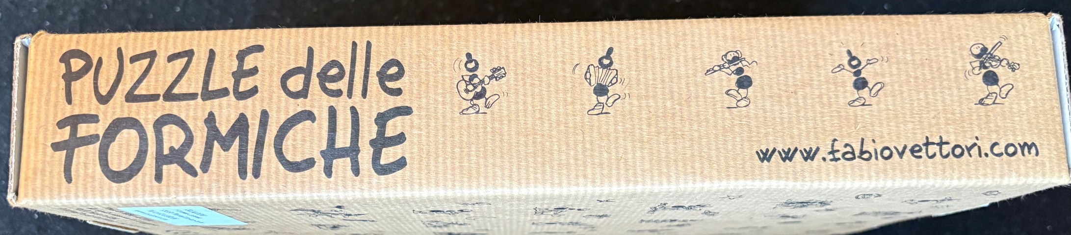 Cartoon ants playing musical instruments on a tan cardboard surface.