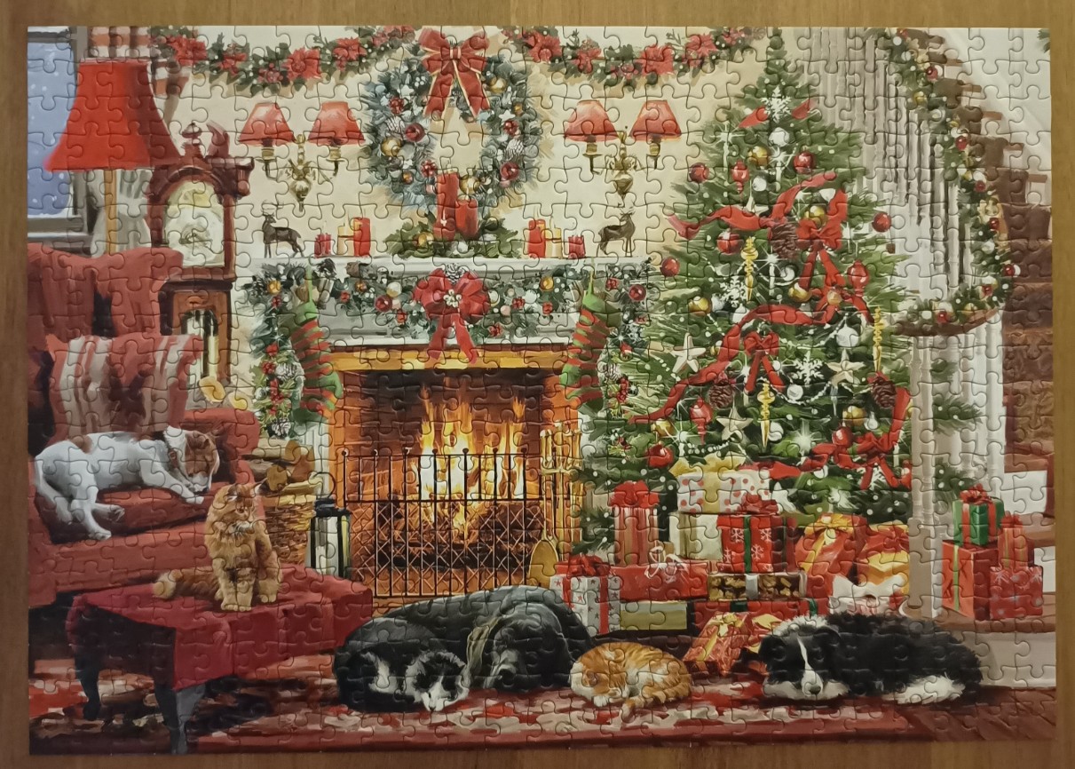 A cozy Christmas living room scene featuring a fireplace, a decorated tree, and several sleeping pets.