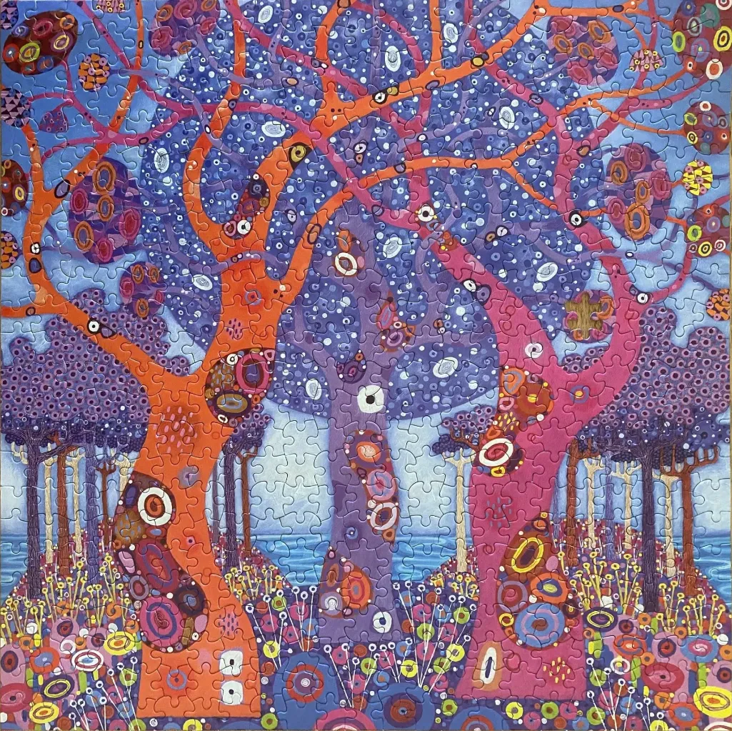 An artistic illustration of stylized trees in vibrant hues of orange, purple, and pink against a blue landscape.