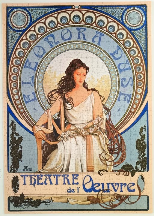 Art Nouveau poster of Eleonora Duse by Alphonse Mucha, featuring a woman in a white gown surrounded by a blue circular frame.