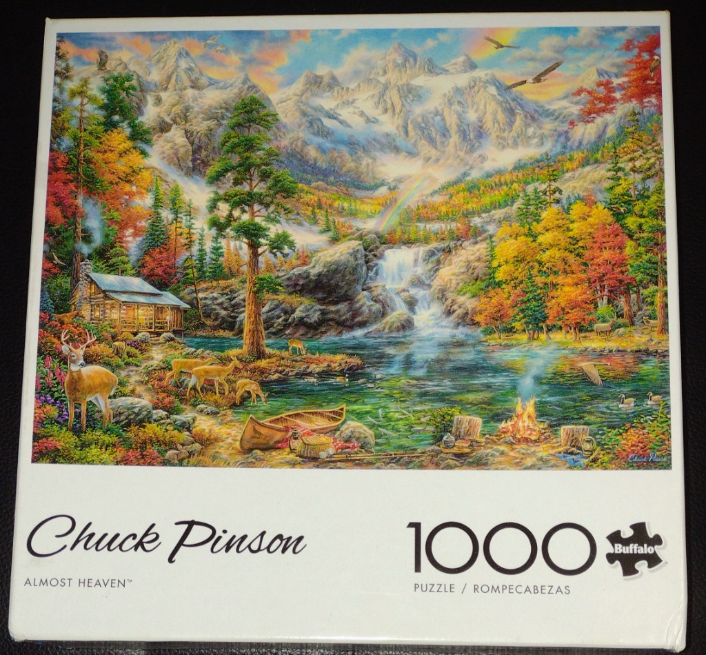A peaceful mountain landscape with a cabin, lake, waterfall, and deer.