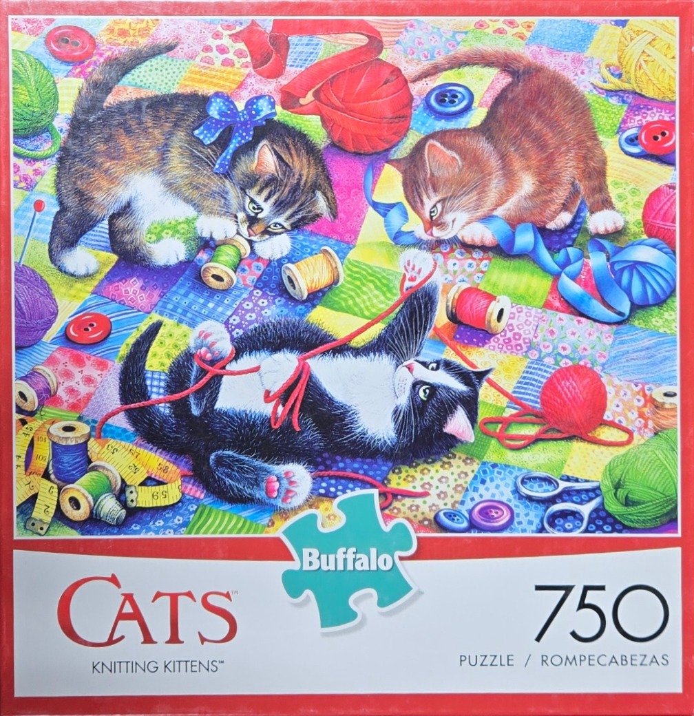 Three kittens playing with knitting supplies on a patchwork quilt background