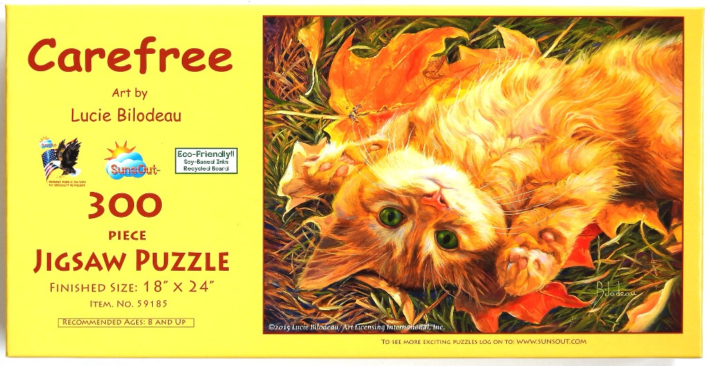 An orange kitten lying on its back in autumn leaves.