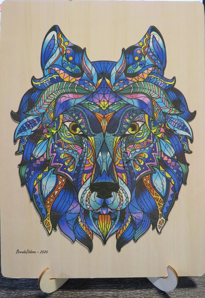 A wolf head illustration featuring intricate, multi-coloured geometric and organic patterns.