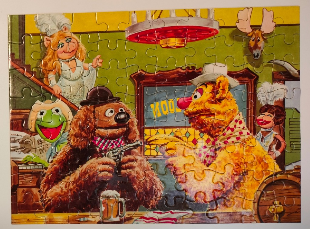 Illustration of Muppet characters performing in a Wild West saloon setting.