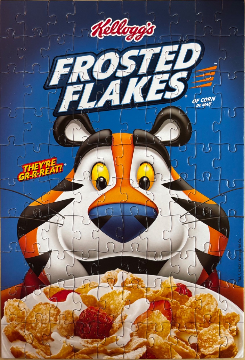 A close-up illustration of the Frosted Flakes tiger mascot looking at a bowl of cereal.