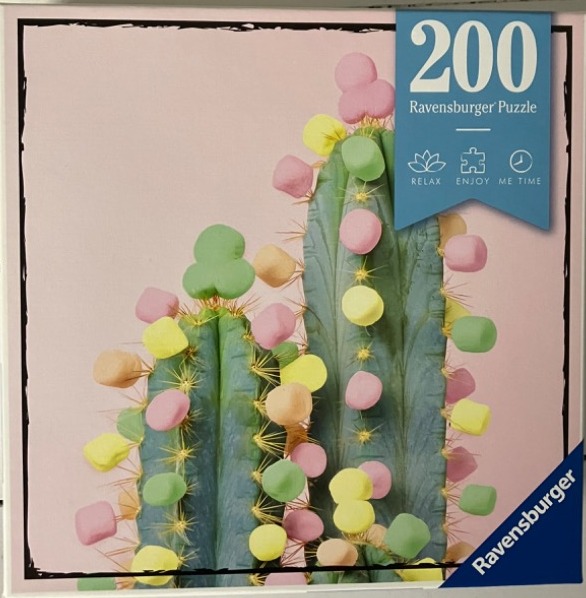 Two tall green cacti decorated with pastel-colored marshmallows against a pale pink background.