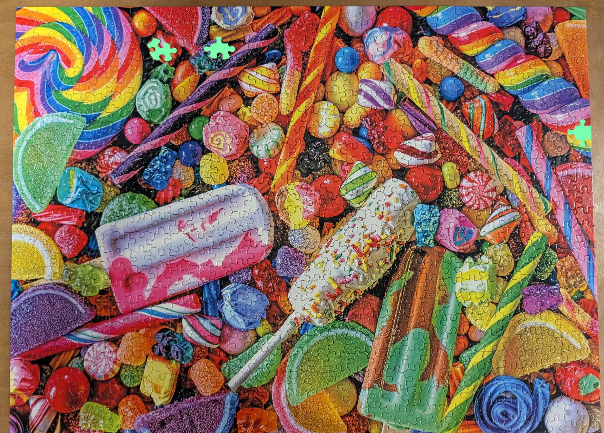A vibrant, high-angle close-up view of a large variety of colourful candies and frozen treats.