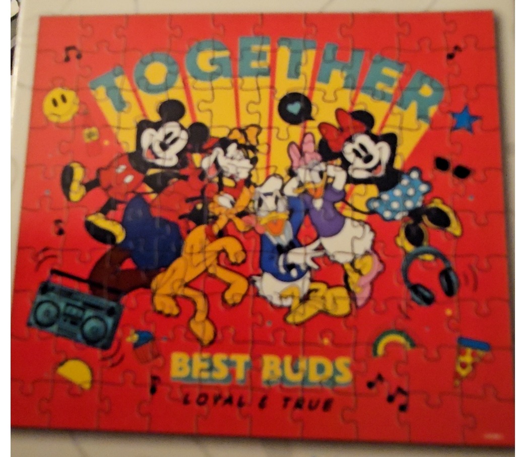 Illustration of classic Disney characters posing together against a bright red, retro-style background.